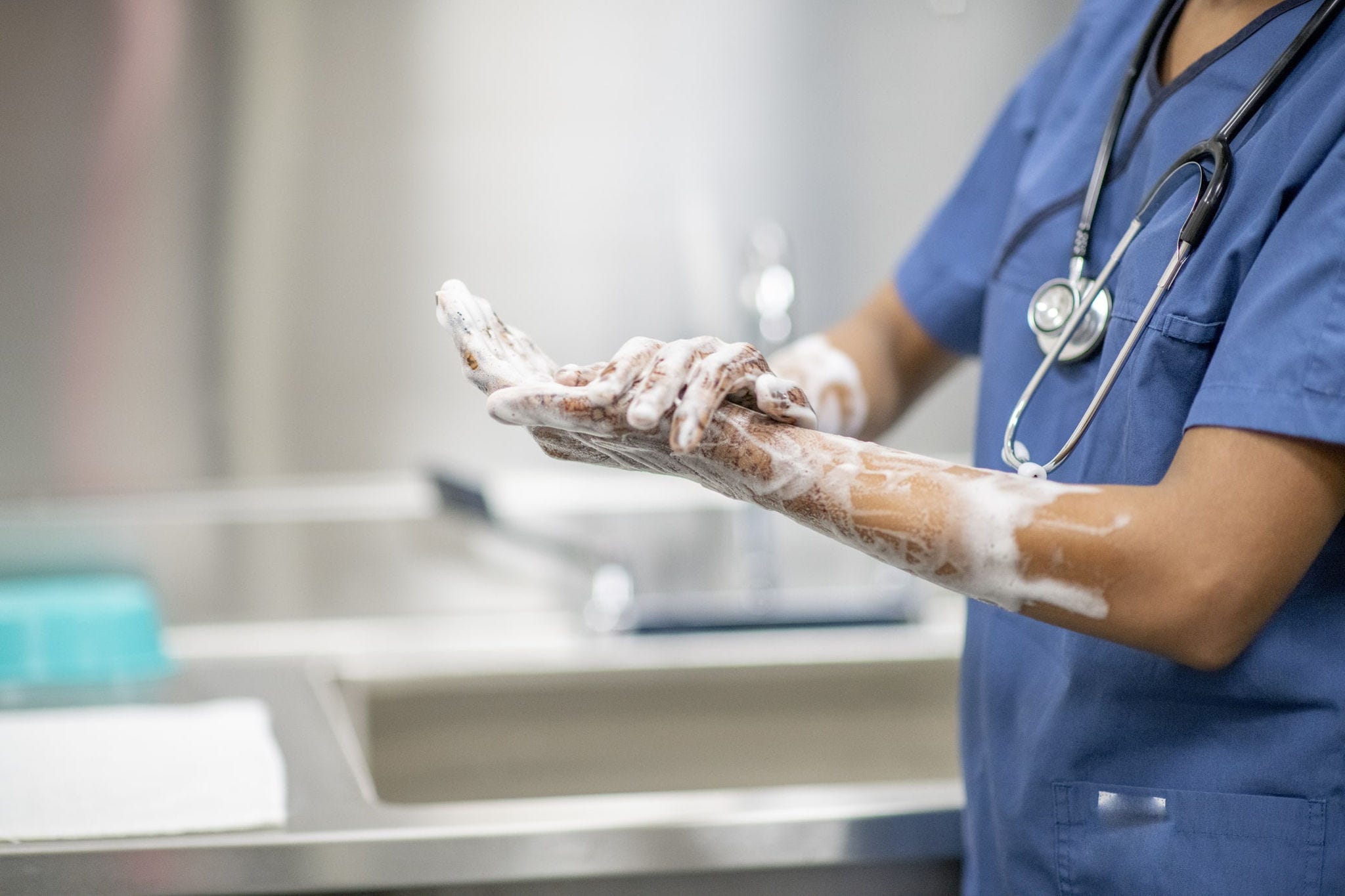 healthcare worker cleaning hands to help prevent infection